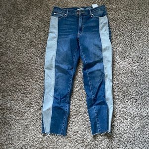 Dark color jeans with a light stripe on the side.